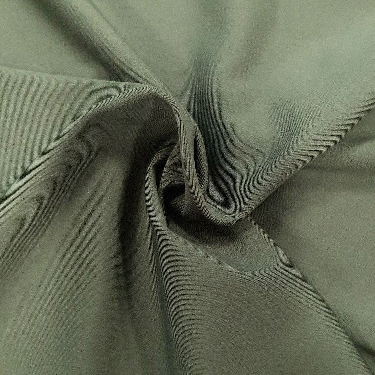 A swirled sample of ecotechflex recycled polyester spandex in the color Moss