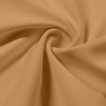A swirled piece of Synergy Polyester Lycra in the color Soft Apricot