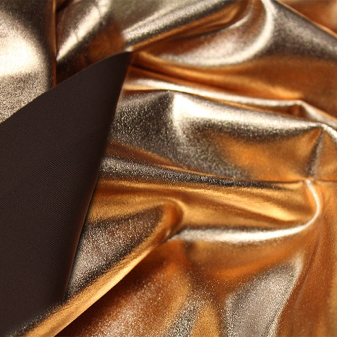 A crumpled piece of Alloy Foiled Spandex with gold foil on brown spandex.