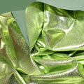 A crumpled piece of Alloy Foiled Spandex with light gree foil on sage spandex.