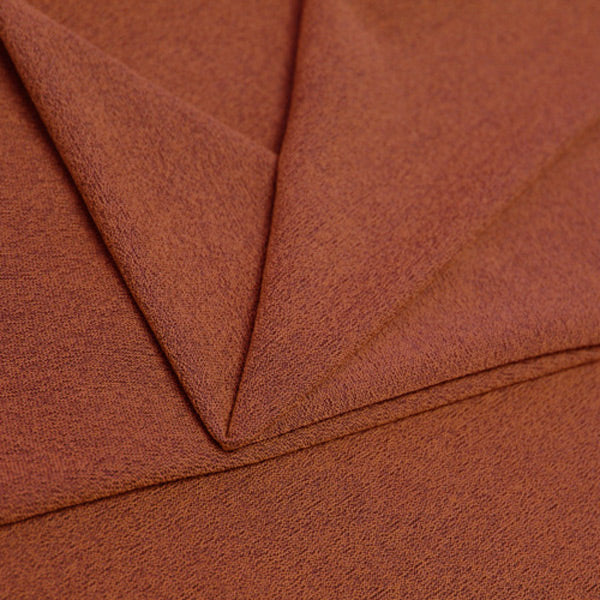 A folded piece of Blast Textured Spandex in Sweet Syrup