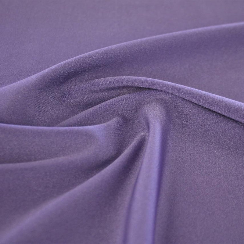 A swirled sample of Charisma shiny nylon spandex in the color iris.