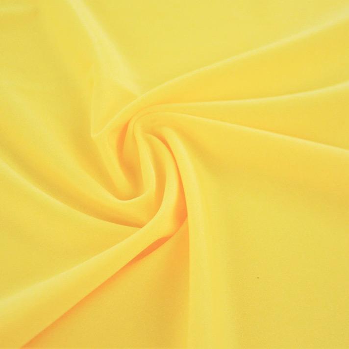 A swirled sample of Charisma shiny nylon spandex in the color sunshine.