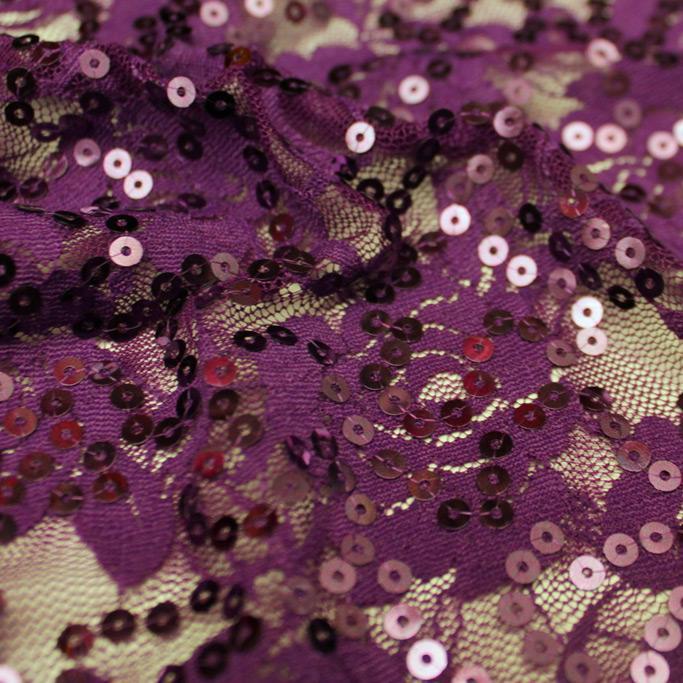 A swirled sample of charlize stretch lace sequin in the color plum.