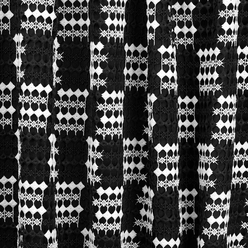 A flat sample of checkmate mechanical lace in the colors black and white.