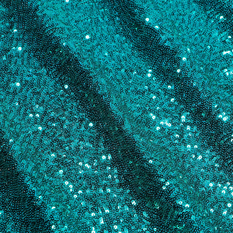 A flat sample of cosmic spandex sequin in the color teal available at blue moon fabrics.