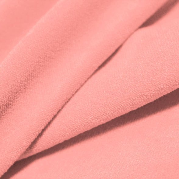 A folded piece of Cozy Polyester Spandex Terry Cloth in the color pinky swear.