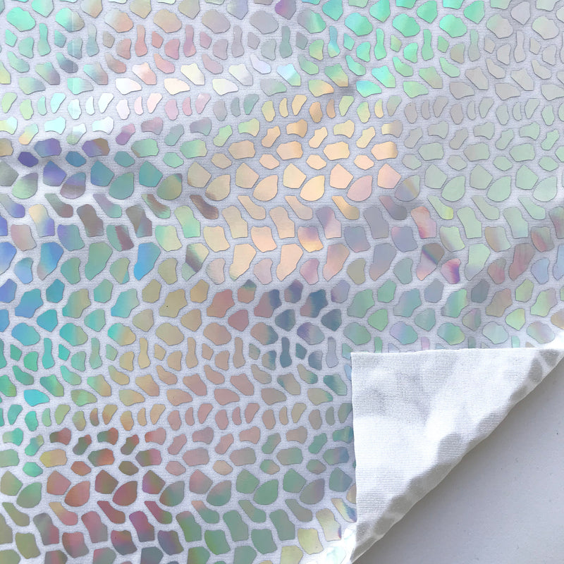 A flat sample of dragon scales holographic spandex sequin in the color silver.