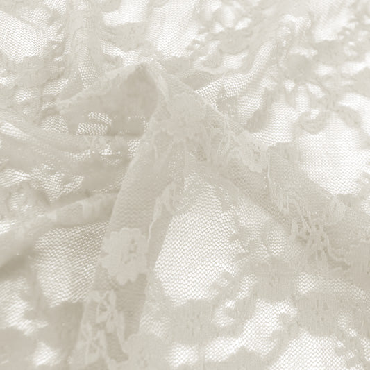 A swirled sample of emma stretch lace in the color off white.