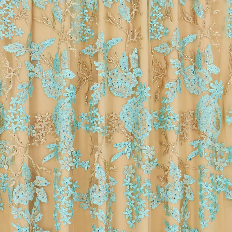 A flat sample of eve embroidered mesh in the color nude-aqua.