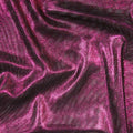 A swirled sample of goddess foiled strtch mesh in the color black-fuchsia.