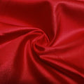 A swirled piece of nylon spandex fabric with an all over shiny look in the color blood red.