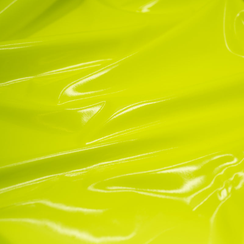 A swirled piece of polyurethane coated polyester spandex in the color Fluorescent-Yellow