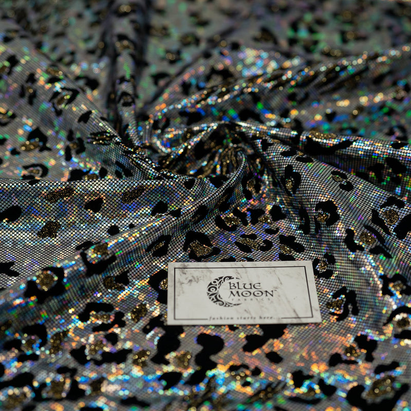 Swirled piece of Jag City Shattered Glass Foiled Spandex Fabric in the color Black-Silver with blue moon fabrics logo
