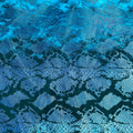 A flat sample of jungle cobra foil printed stretch velvet in the color blue.