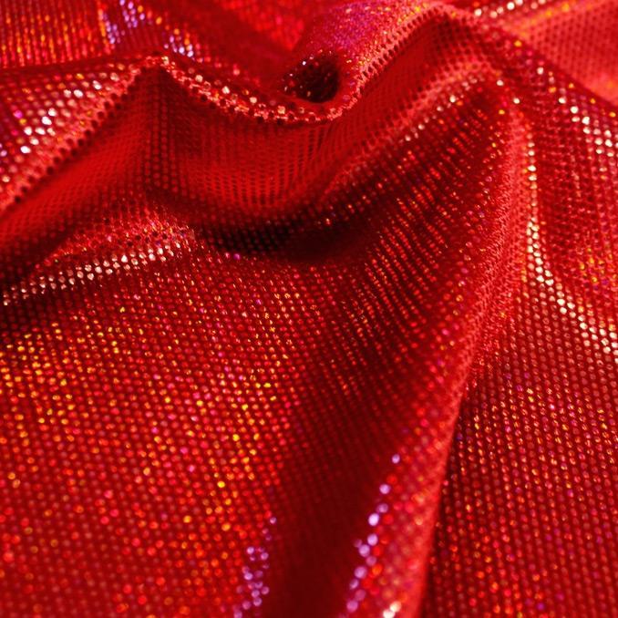 A swirled sample of legacy foiled stretch velvet in the color ruby-red.