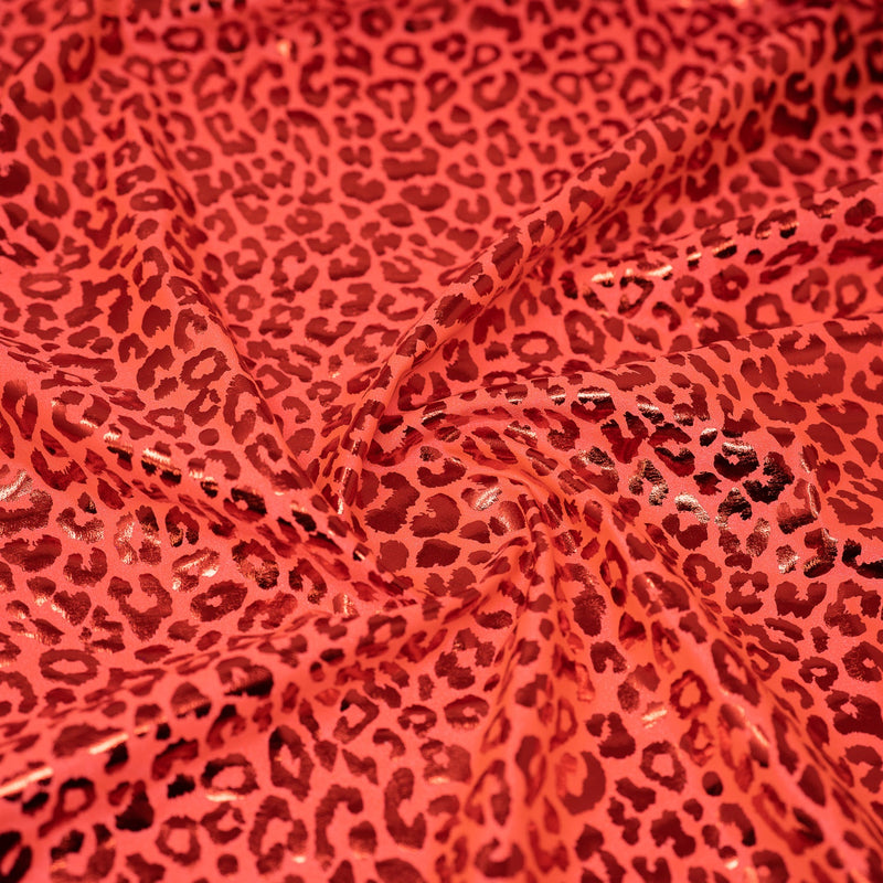 Detailed shot of Loud Leo Foil Printed Spandex in Burnt Orange/Red.