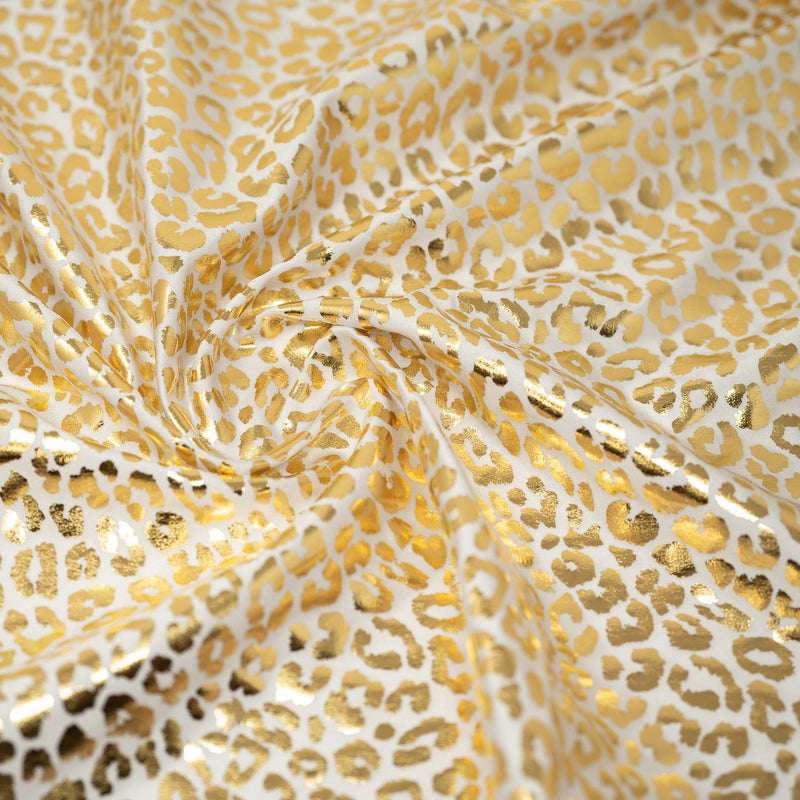 Detailed shot of Loud Leo Foil Printed Spandex in Snow White/Gold.
