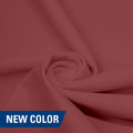 A swirled piece of matte nylon spandex fabric in the color champagne.