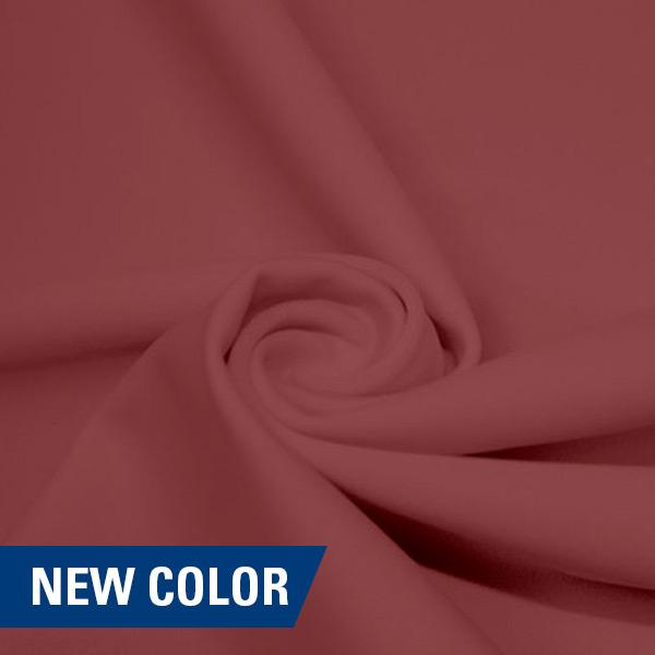 A swirled piece of matte nylon spandex fabric in the color champagne.