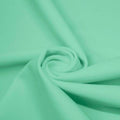 A swirled piece of matte nylon spandex fabric in the color menthol.
