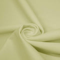A swirled piece of matte nylon spandex fabric in the color pearl.