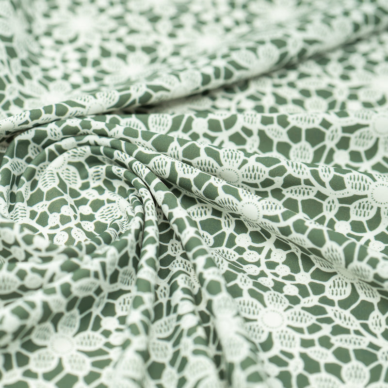 Swirled sample shot of White Flower Lace Pattern on Sage Printed Spandex