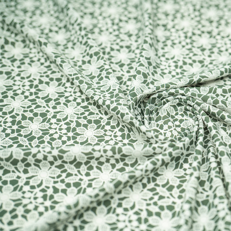 Swirled sample shot of White Flower Lace Pattern on Sage Printed Spandex