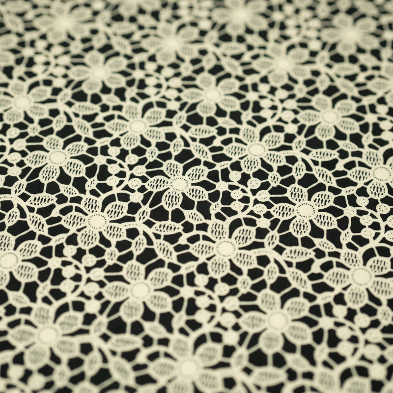 A flat sample of Ivory Flower Lace Pattern on Black Printed Spandex