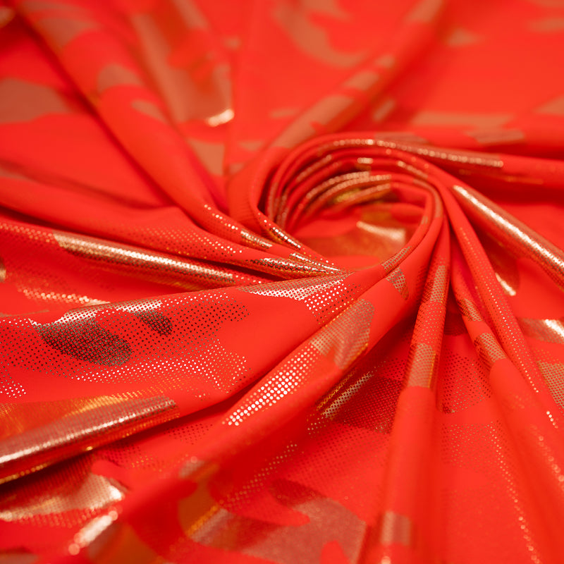 Detailed shot of Neon Nugi Foil Printed Cationic Spandex in color Coral Gold.