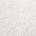 A falt sample of olivia stretch lace in the color white.