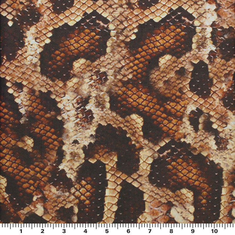 A flat sample of desert snake power mesh with a scale to measure the size of the print.