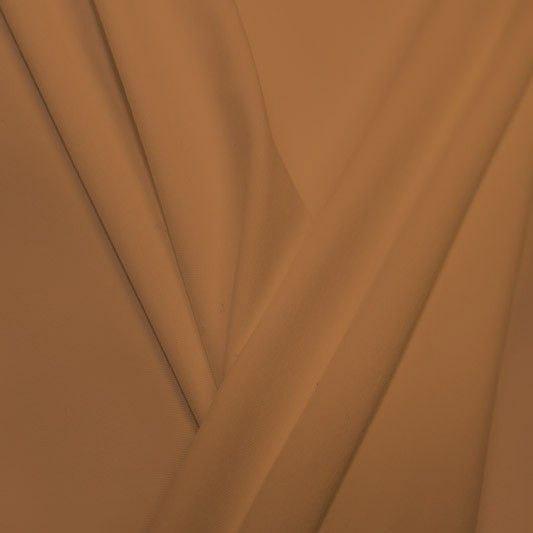 A pleated piece of performance nylon spandex fabric in the color nude.
