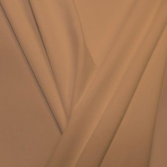 A pleated piece of performance nylon spandex fabric in the color sun beige.
