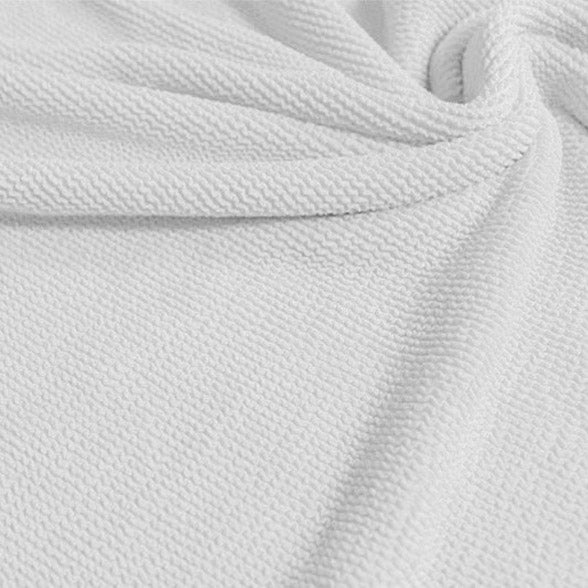 A swirled sample of popcorn polyester spandex jacquard in the color white.