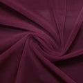 A swirled piece of nylon spandex power mesh in the color plum gorgeous.