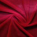 A swirled piece of nylon spandex power mesh in the color scarlet.