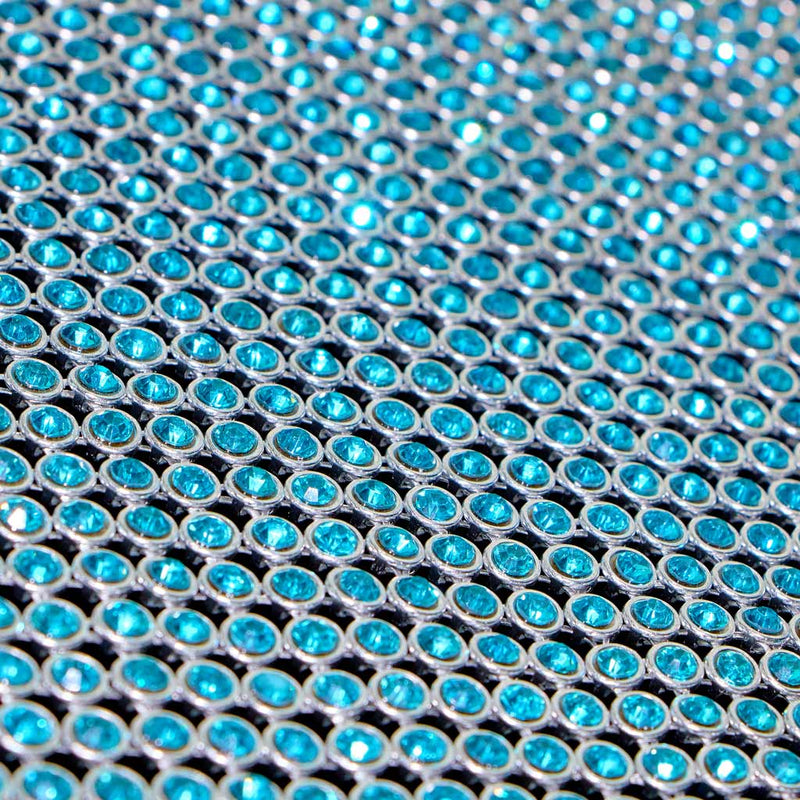 A flat sample of rhinestone aluminum scale mesh in the color aqua.