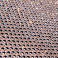 A flat sample of rhinestone aluminum scale mesh in the color gold.