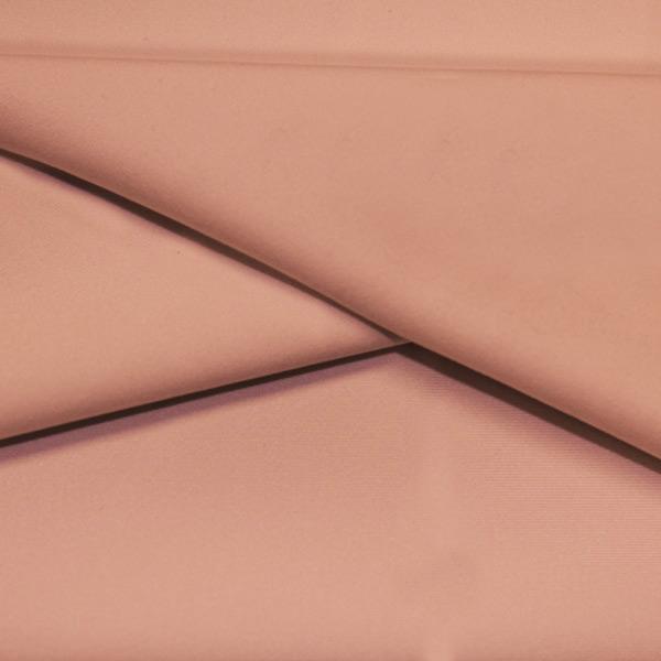 A folded piece of Ripple Recycled Polyester Spandex in the color rosy peach.