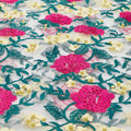 A flat sample of rose and vine embroiered mesh in the colors yellow-pink-white.