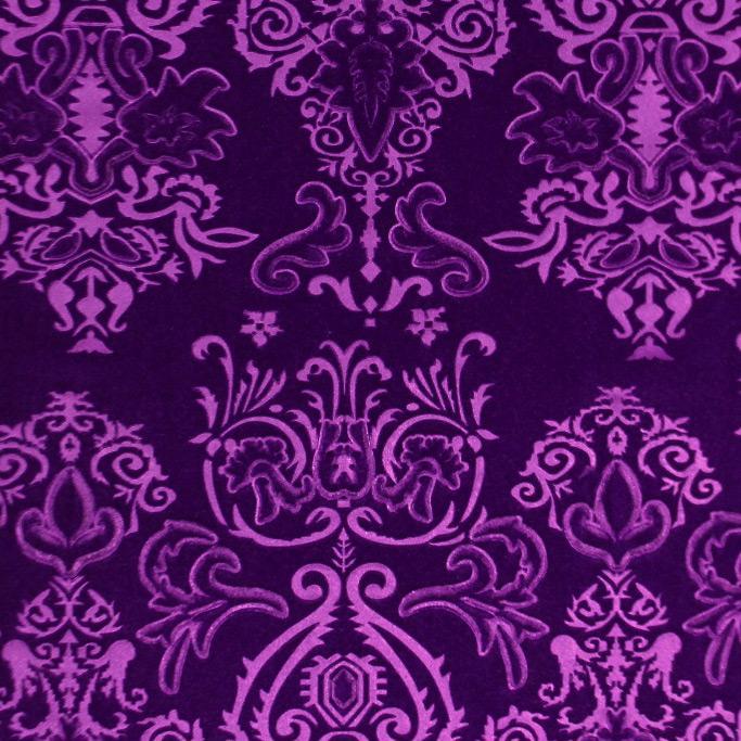 A flat sample of royalty embossed tretch velver in the color purple.