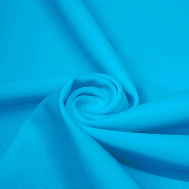 A swirled piece of microfiber nylon spandex in the color Celeste Blue