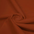 A swirled piece of microfiber nylon spandex in the color Copper