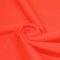 A swirled piece of microfiber nylon spandex in the color Coral
