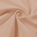 A swirled piece of Synergy Polyester Lycra in the color nude.