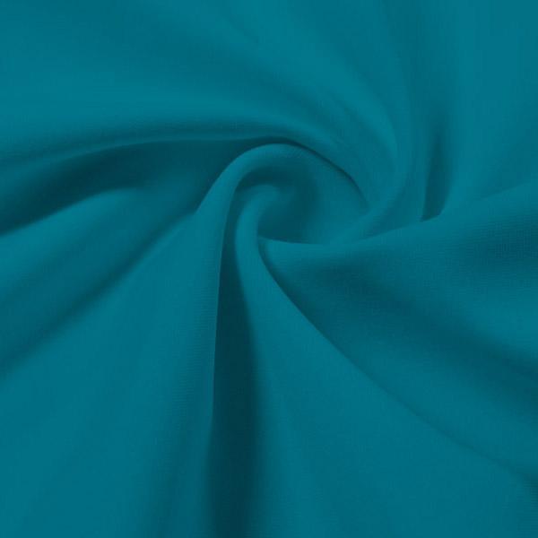 A swirled piece of Synergy Polyester Lycra in the color tropical teal.