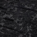 A flat sample of versailles burn out stretch velvet in the color black.