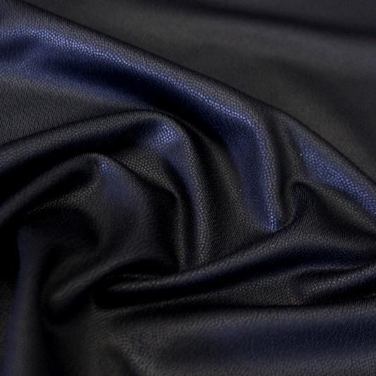 A swirled piece of Mystique foiled microflex spandex with matte black foil on a black base.