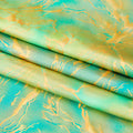 A foiled sample of Tie Dye Thunder Hologram Spandex Fabric in color lime/green/gold.